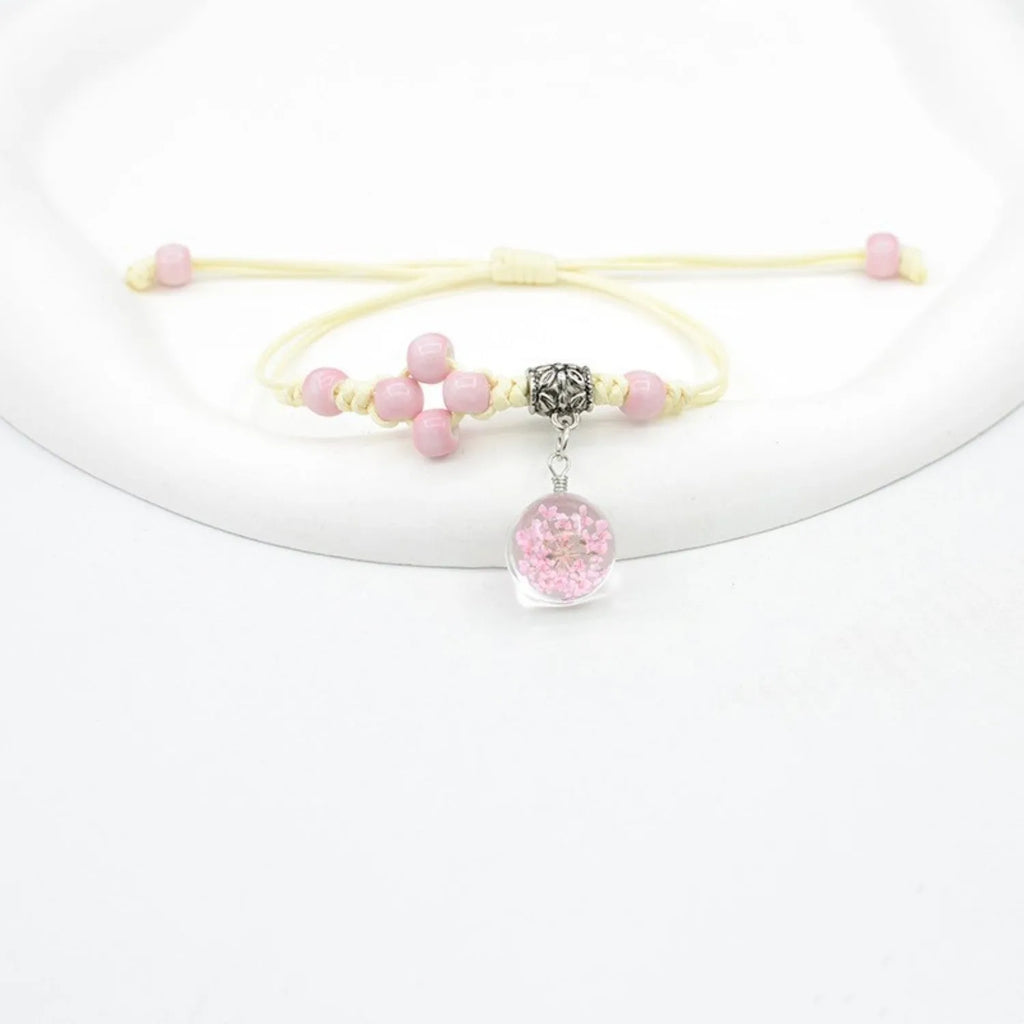 Glass dried flower bracelet with preserved flowers inside clear beads, available in multiple colours