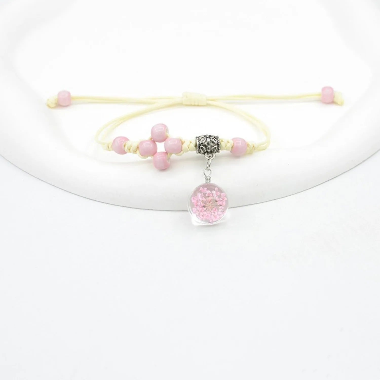 Glass dried flower bracelet with preserved flowers inside clear beads, available in multiple colours