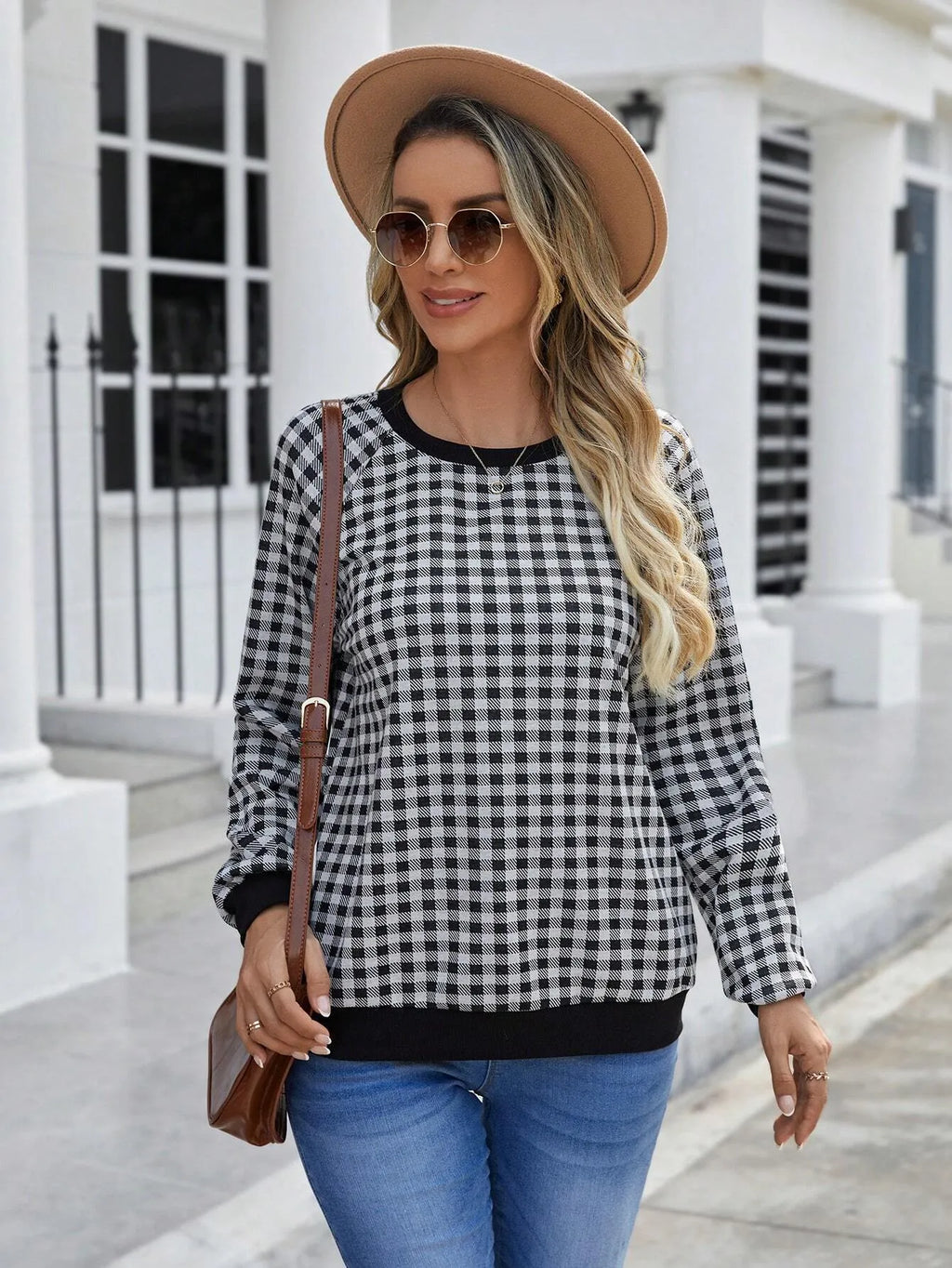 Black Japanese plaid pattern long sleeve pullover sweater on a hanger.