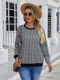 Black Japanese plaid pattern long sleeve pullover sweater on a hanger.