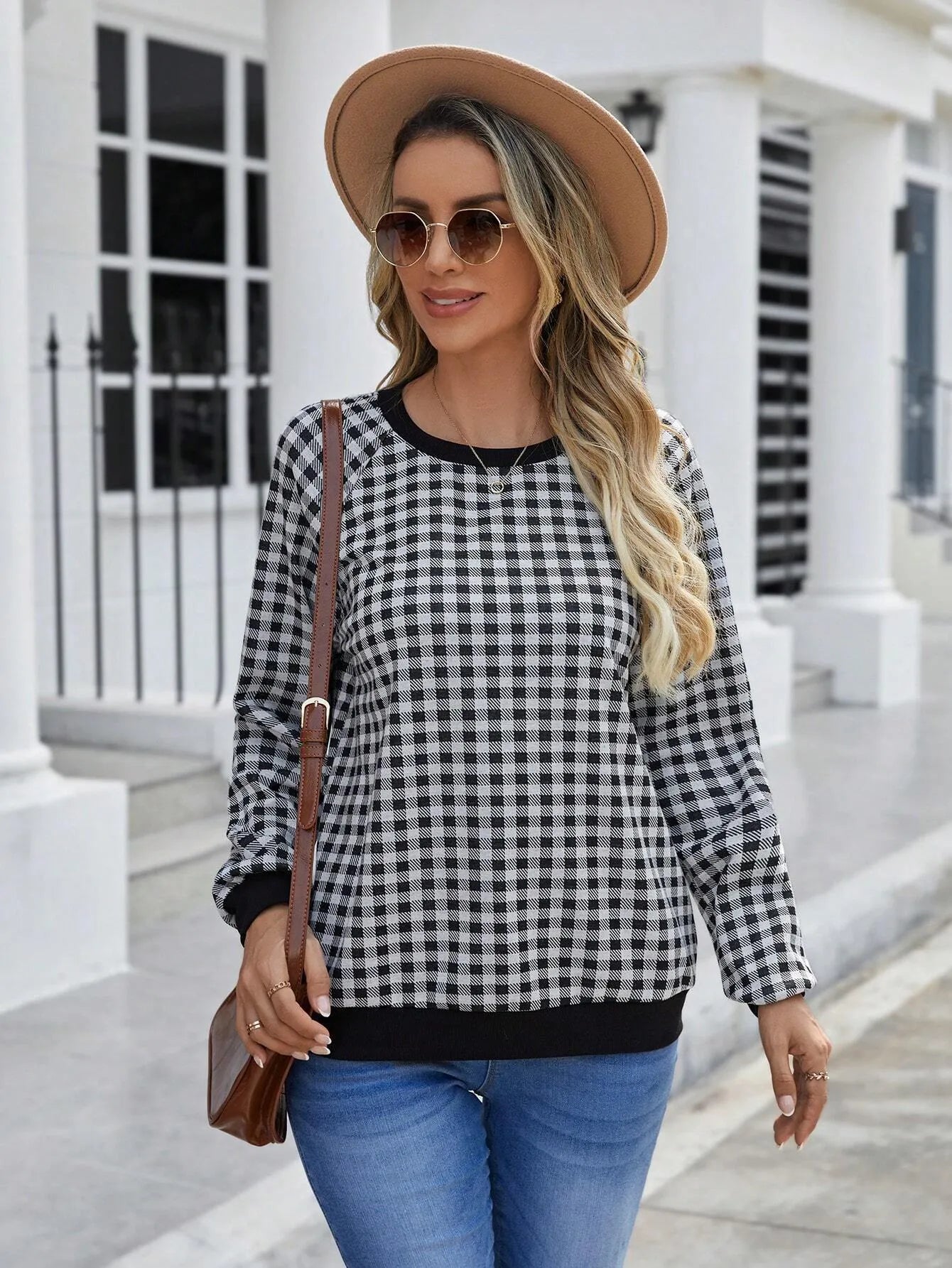 Black Japanese plaid pattern long sleeve pullover sweater on a hanger.