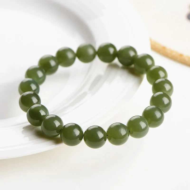 Polished Hetian jade bead bracelet in ice clear colour on a wrist, showing bead detail.