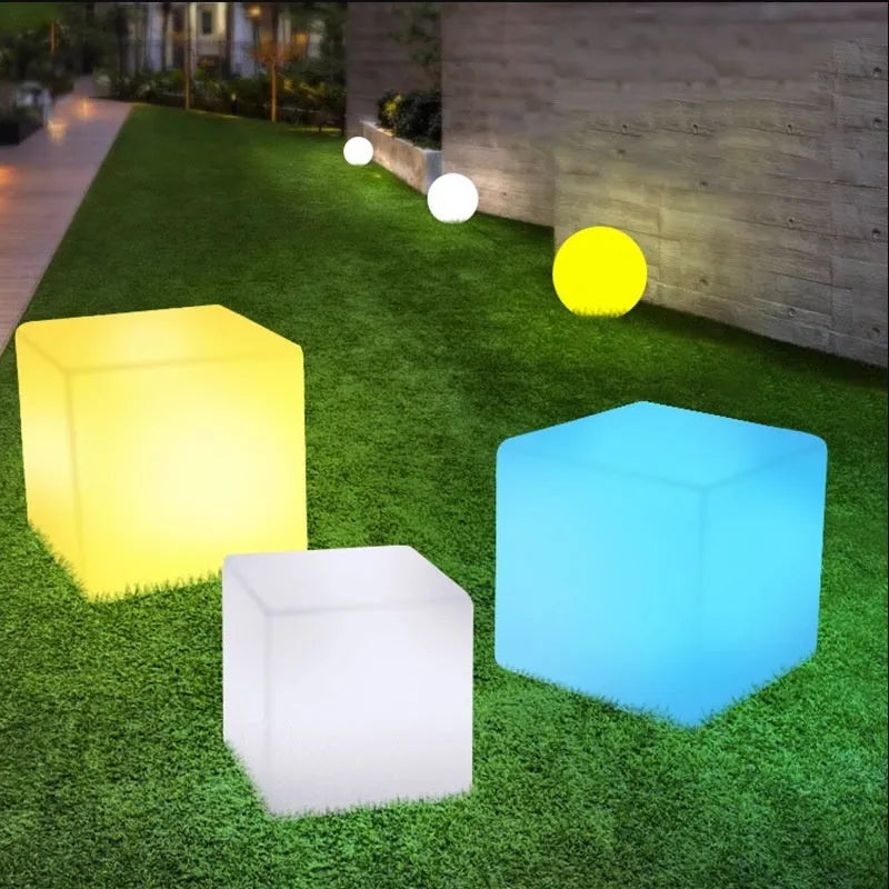 Modern square white LED cube stool light for garden patio with solar panel on top.