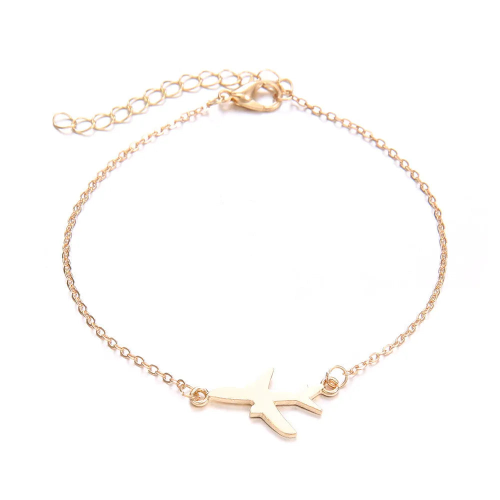 Three bohemian bracelets with heart-shaped aircraft map charms in silver tone