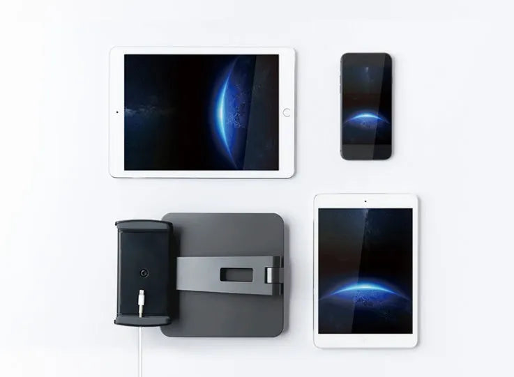 Black foldable aluminium phone and tablet stand with 360-degree rotation on a wooden desk