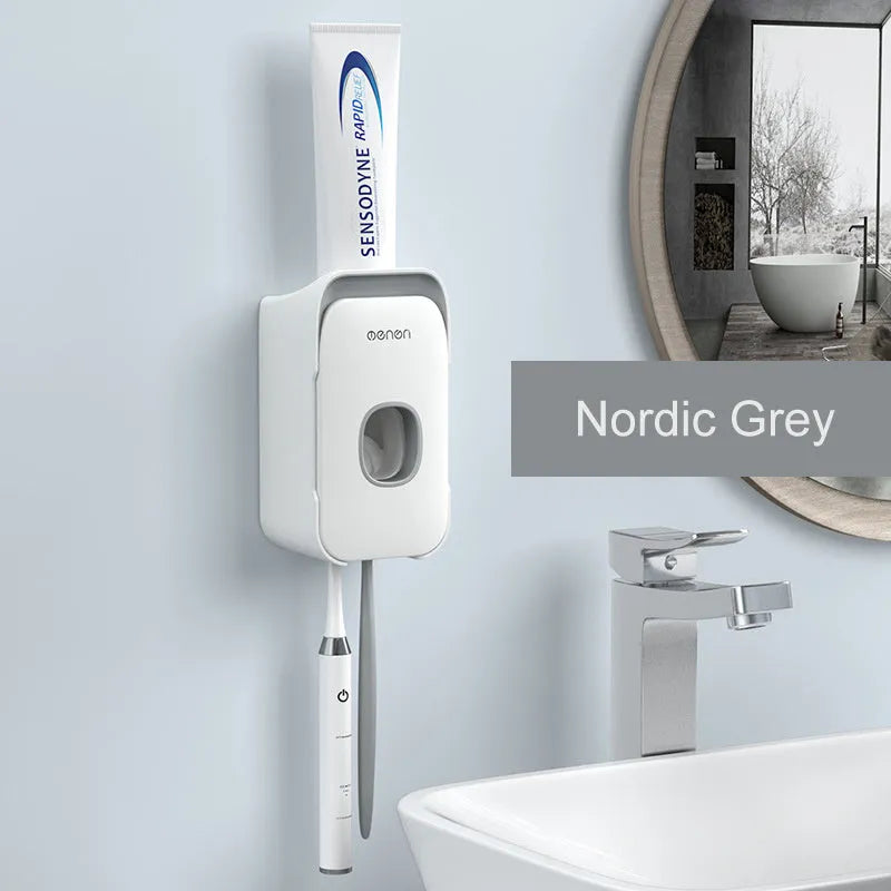 Blue automatic toothpaste dispenser with wall-mount bracket on a bathroom wall