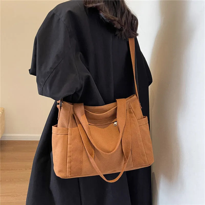 Large solid colour polyester canvas shoulder tote bag for women with internal mobile phone pocket.
