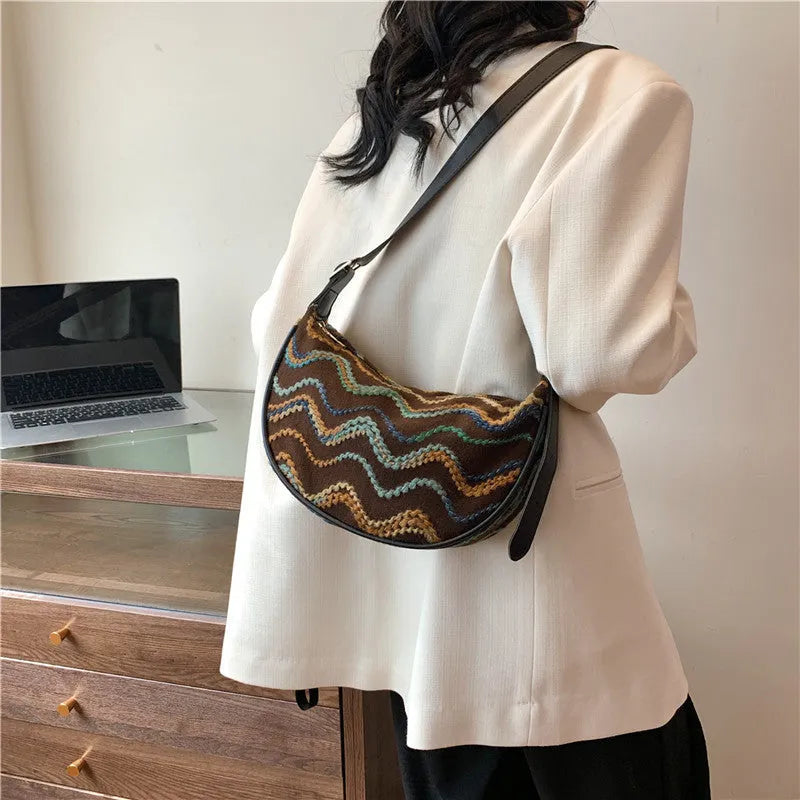 Women's woven straw crossbody bag with single strap and internal phone pocket