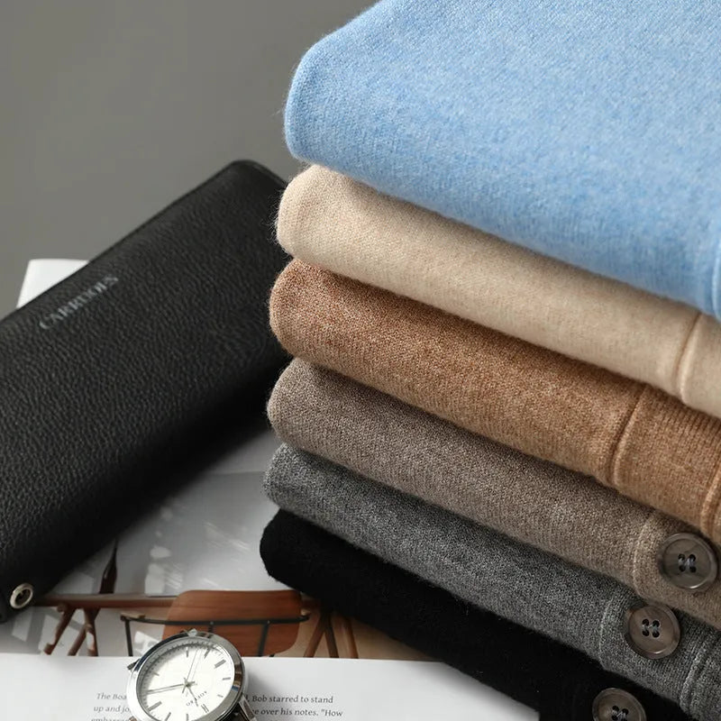 Man wearing a loose beige Andy Velvet V-neck cardigan coat with long sleeves.