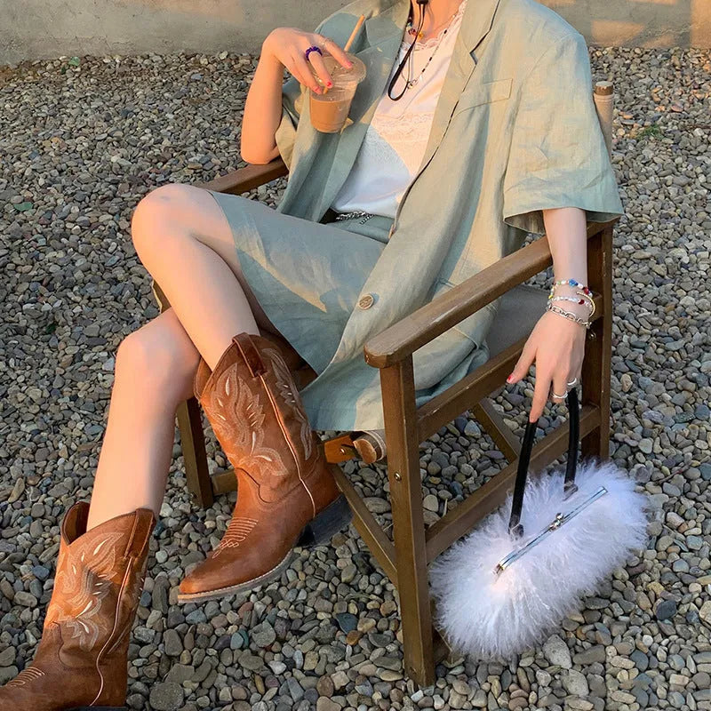 Brown embroidered women's mid-calf Martin boots on a waterproof platform with a square heel.