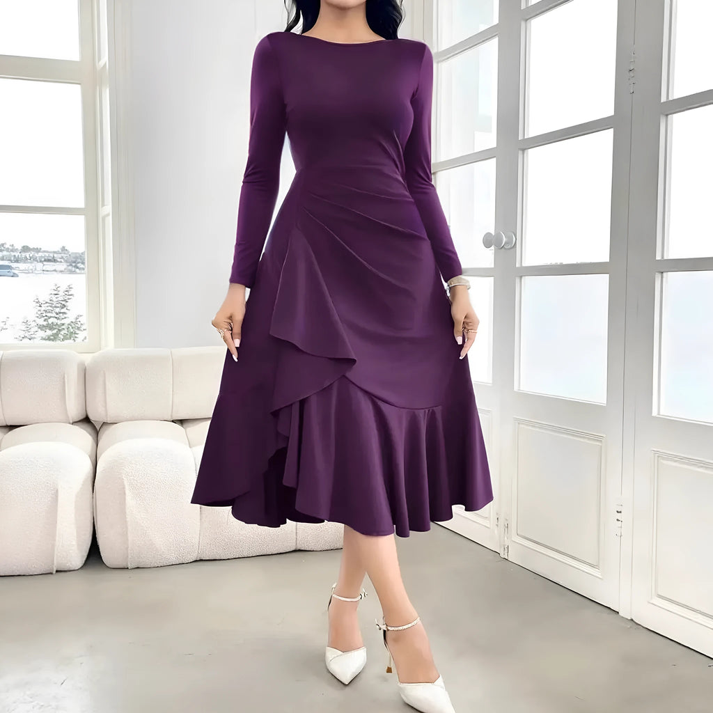 Purple women's long sleeve dress with round neck, mid waist, and ruffle detail on a hanger.
