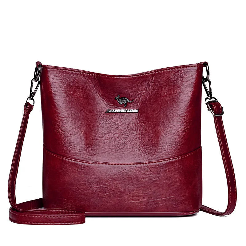 Women's soft leather shoulder bag in bucket design with minimalist luxury styling and mobile phone pocket