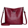 Women's soft leather shoulder bag in bucket design with minimalist luxury styling and mobile phone pocket