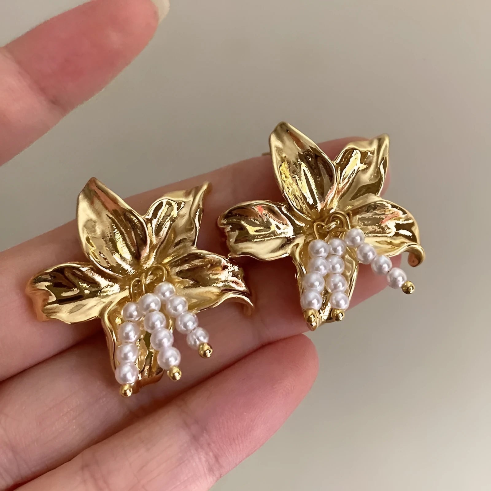 Golden flower earrings with pearl designs and exaggerated floral shape for women