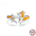 Close-up of a silver-coloured adjustable ring with a detailed cartoon corgi dog design on its face.
