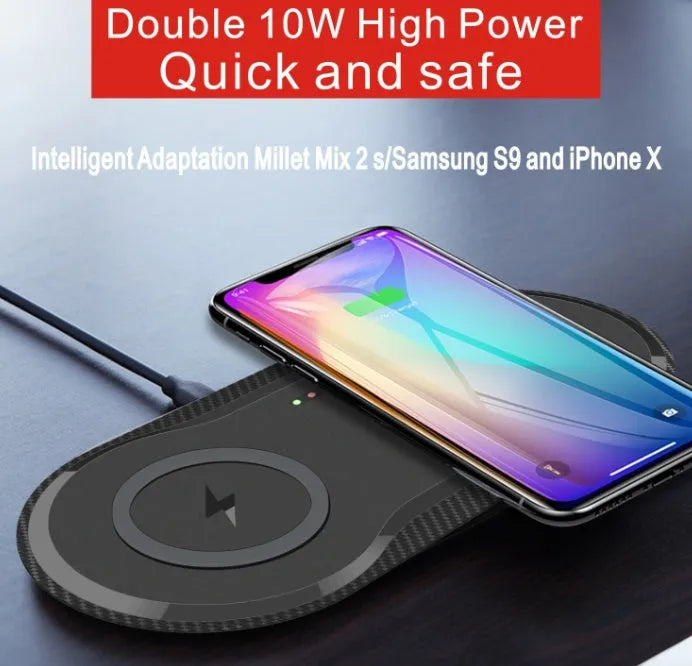 Black and white dual Qi wireless charging pad charging two smartphones simultaneously