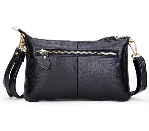 Cowhide lady's slant bag showing front compartment, adjustable long shoulder strap, and hand strap in a choice of colours