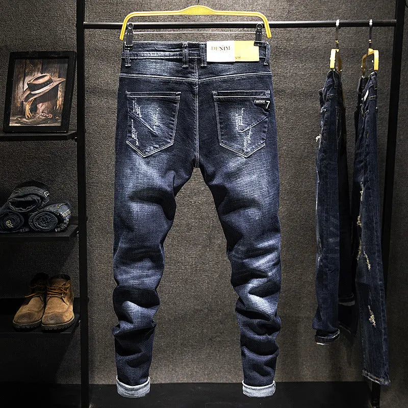 Men's dark blue skinny jeans with a slim fit, shown on a model.