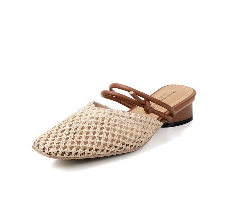 Women's black square toe slippers with chunky heel and breathable hollow-out design on a wooden floor