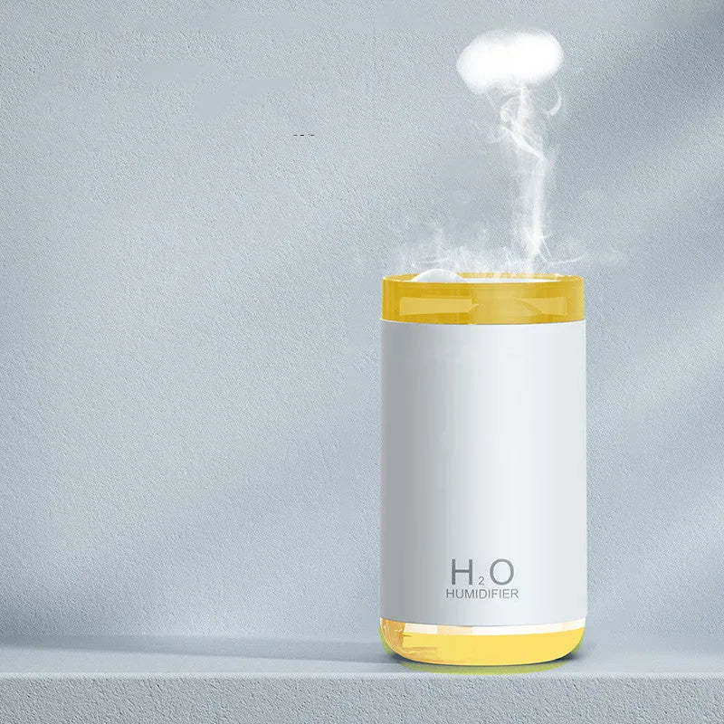White jellyfish-themed USB humidifier with warm night light on a wooden table.