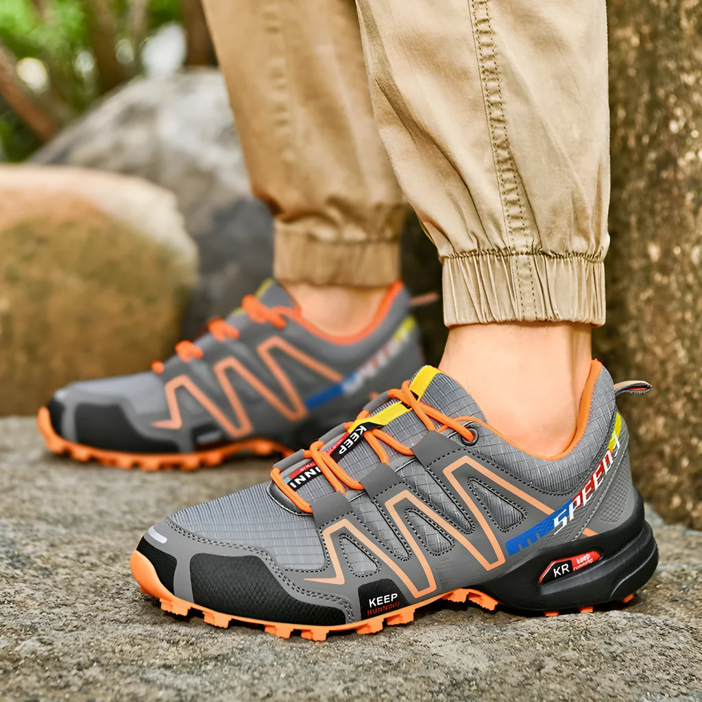 Men's grey orange plus size casual running shoes with low-top design on a plain background.