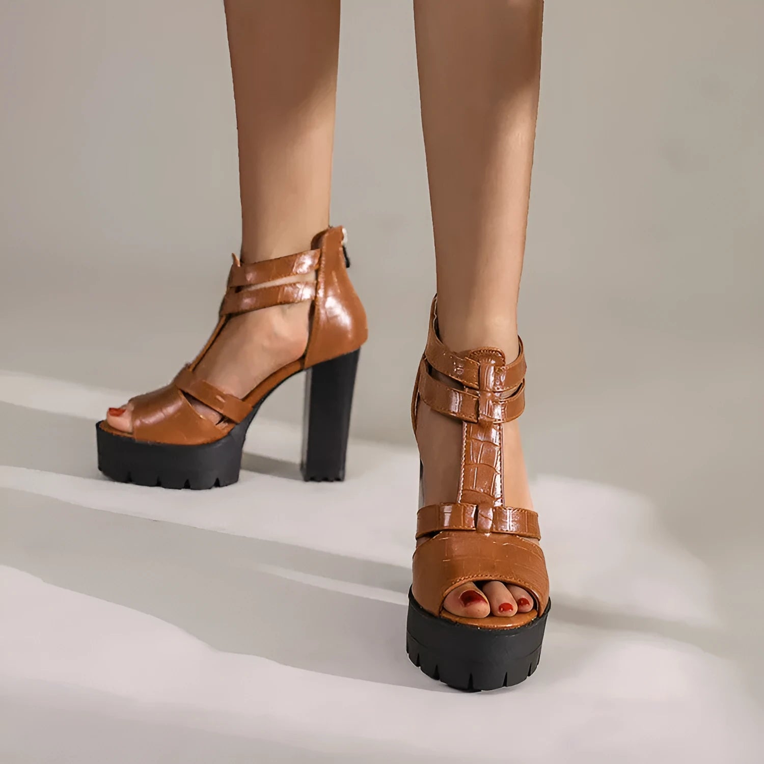Women's black platform high heel sandals with a back zip, round toe, and a rubber sole.