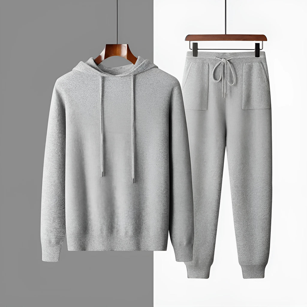 Men's light grey hooded cashmere sweatshirt and matching trousers laid flat as a complete casual set.
