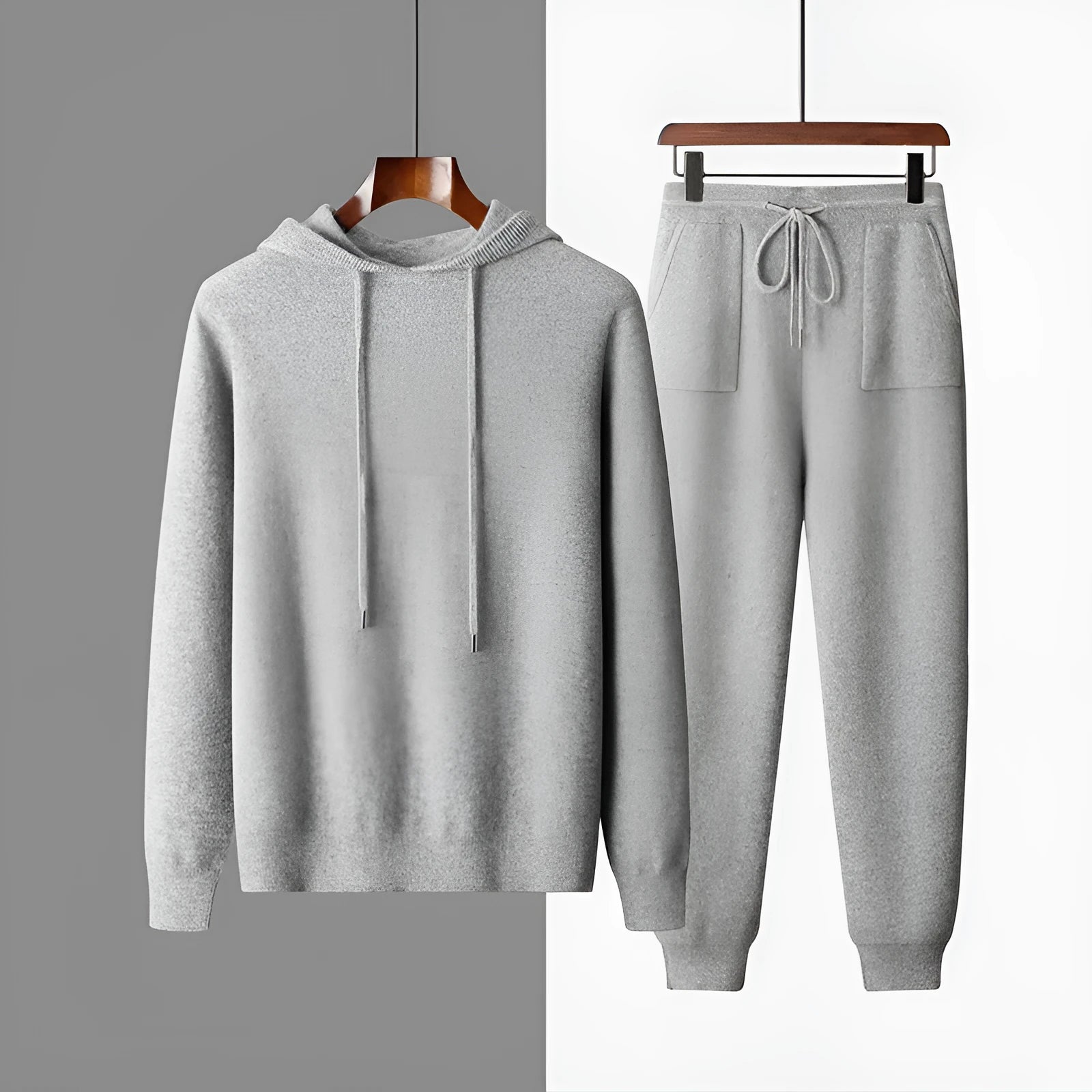 Men's light grey hooded cashmere sweatshirt and matching trousers laid flat as a complete casual set.