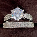 White gold colour geometric alloy wedding ring on a finger, showing its simple round band design.