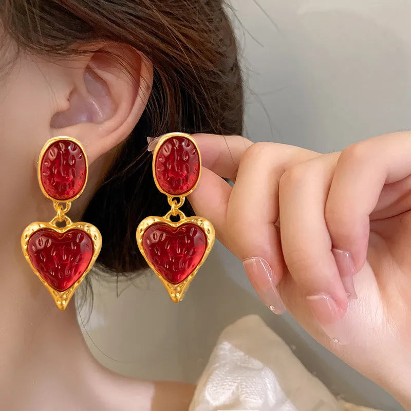 Purple, red, green, and yellow and white alloy pleated oval love heart stud earrings on silver posts.