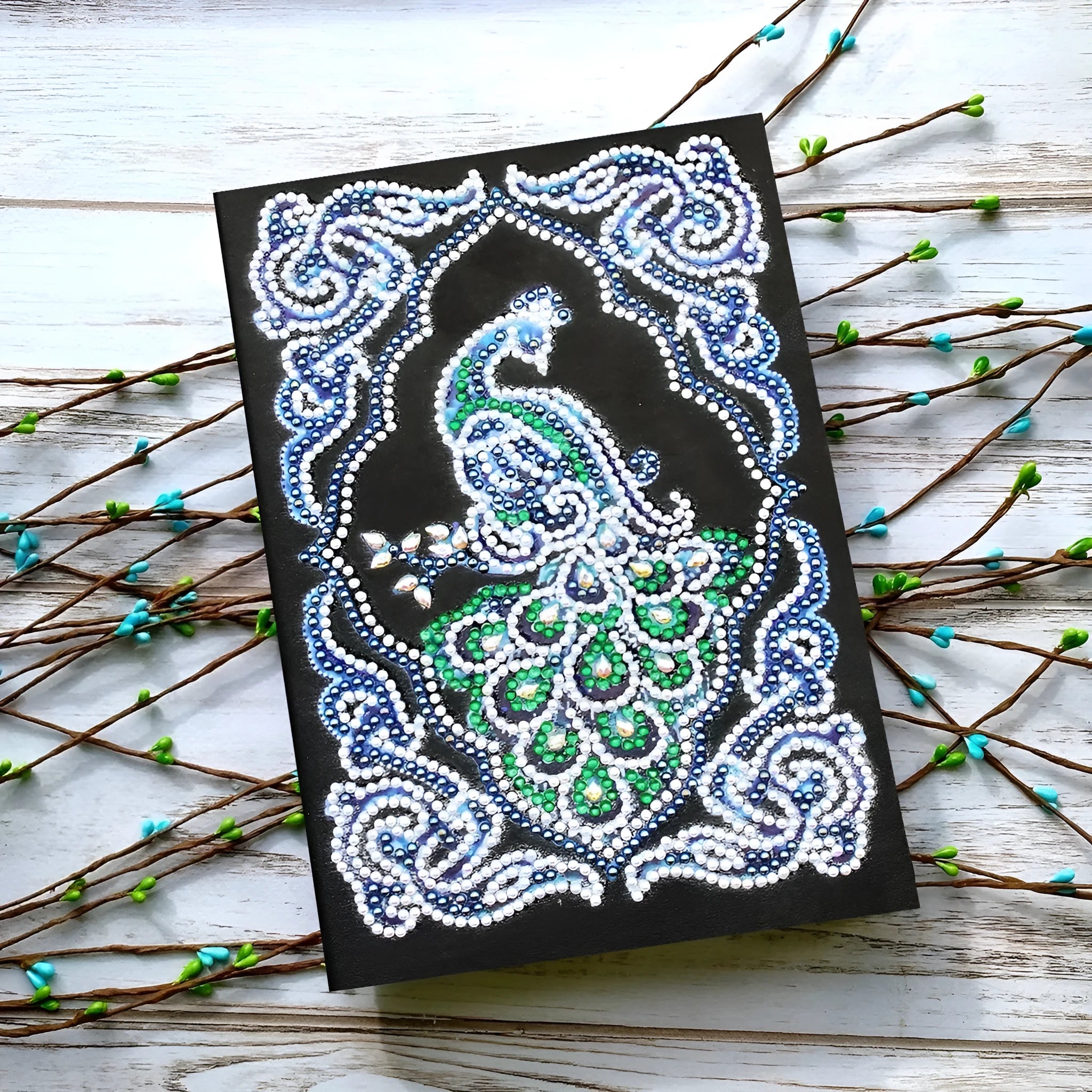 Black A5 diamond painting notebook featuring a peacock pattern with shaped and bright resin drills.