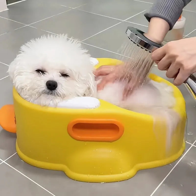 Blue PVC pet bath tub shaped like a duck for washing dogs and cats, shown on a bathroom floor.