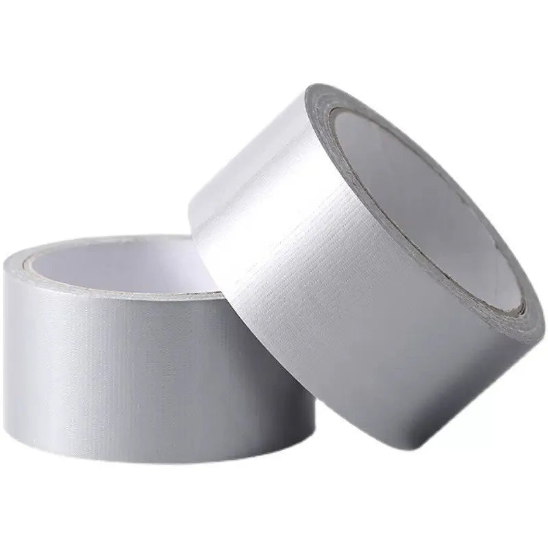 Roll of high-adhesive thickened windproof sealing tape in transparent colour on a windowsill.