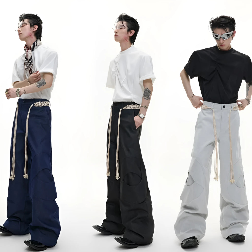 Man wearing dark blue straight leg jeans with belt stitching and decorative details