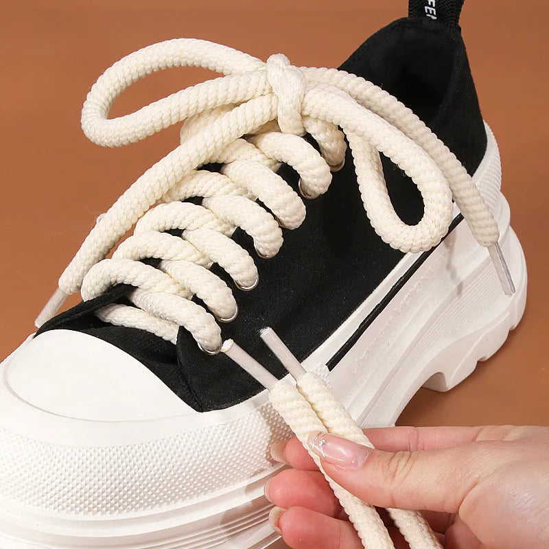 Round woven shoelaces for Bread Shoes in white, beige and black colours on a white background.