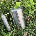 Silver stainless steel dumbbell cup weight plate weighing 8kg on a gym floor.