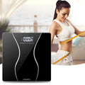 Black electronic digital bathroom scale on a bathroom floor