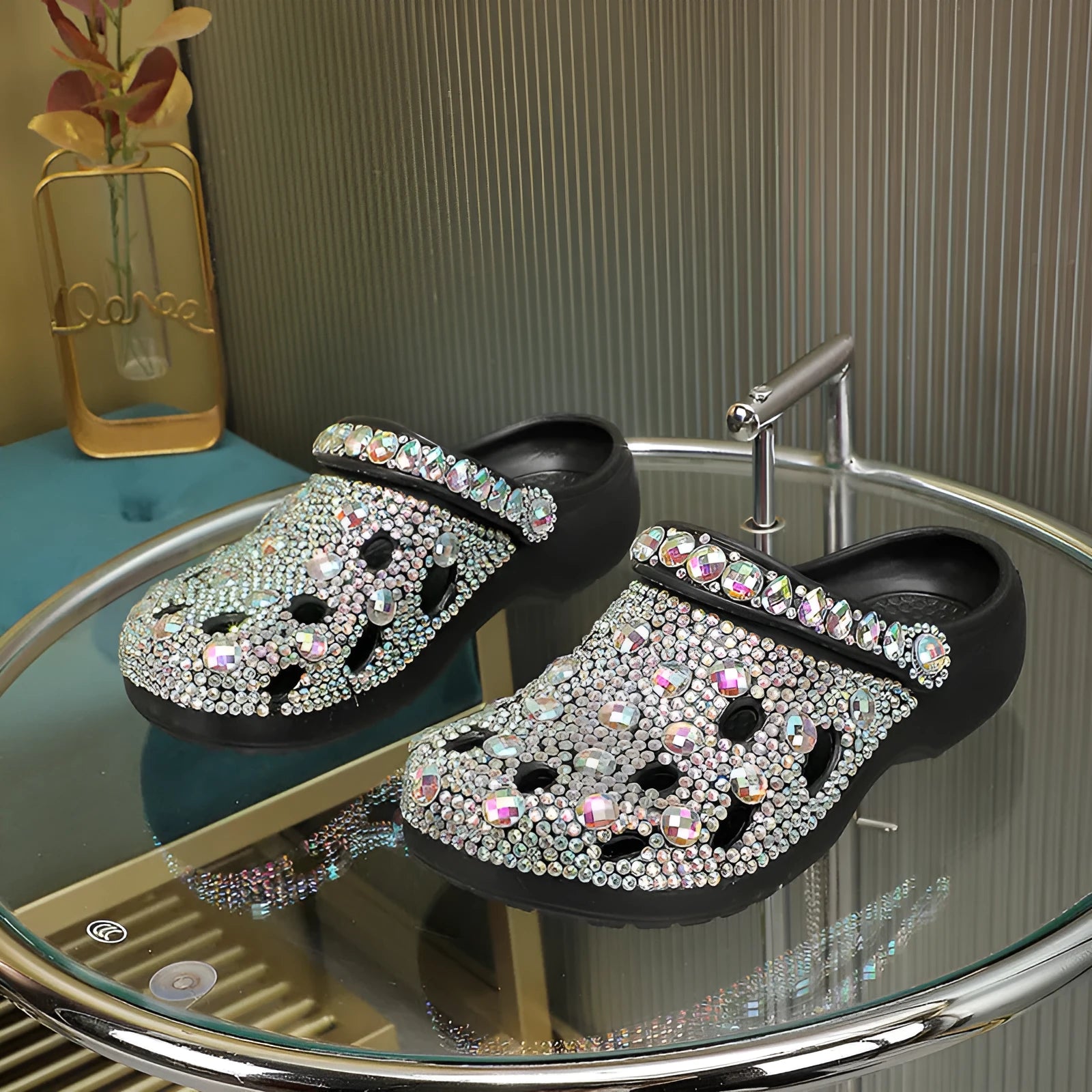 Black women's platform sandals with rhinestone decoration and multiple air holes on a white background.