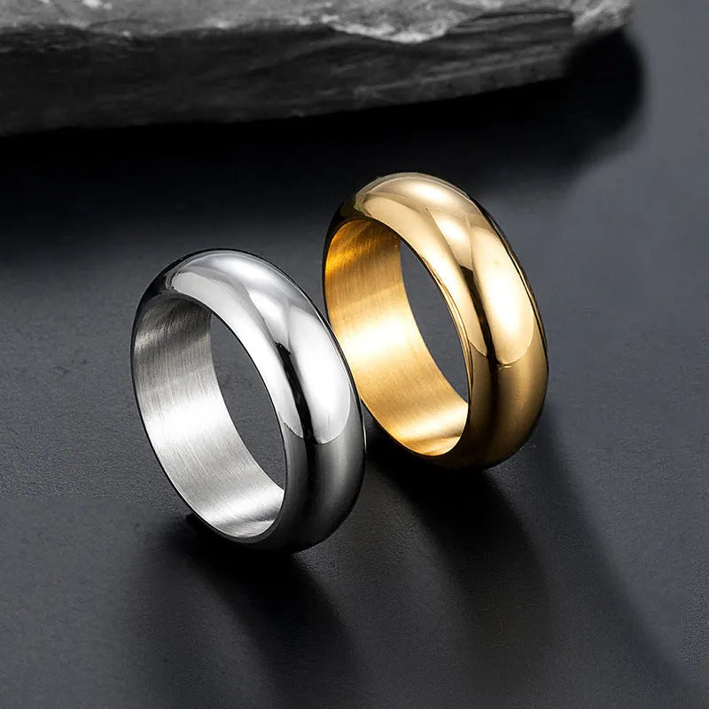 Glossy electroplated titanium steel ring shown in gold, black, and steel colour on a grey background.