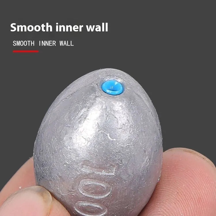Rugby-shaped olive lead fishing sinker with scale texture pattern and plastic core construction