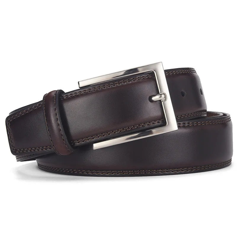 Men's classic black patent leather belt with a silver pin buckle on a flat surface.