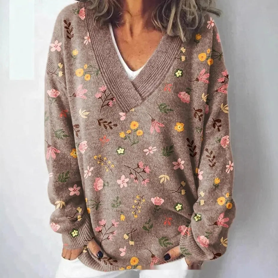 Women's V-neck sweatshirt with a white background and a textured 3D floral printed pattern.