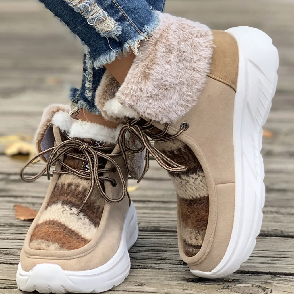 Beige women's lace-up snow boots with a suede upper, thick rubber sole, and plush lining.