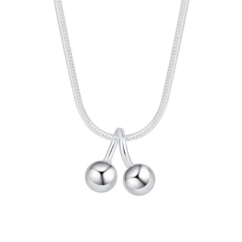 Silver cherry necklace for women with fruit pendant on a snake bone chain, adjustable length.