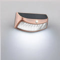 Solar-powered outdoor wall light with retro smiling face design for garden or courtyard.