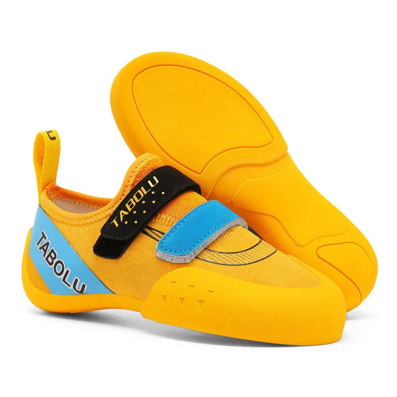 Beginner rock climbing shoes with Velcro strap and rubber sole in black and red colour combination