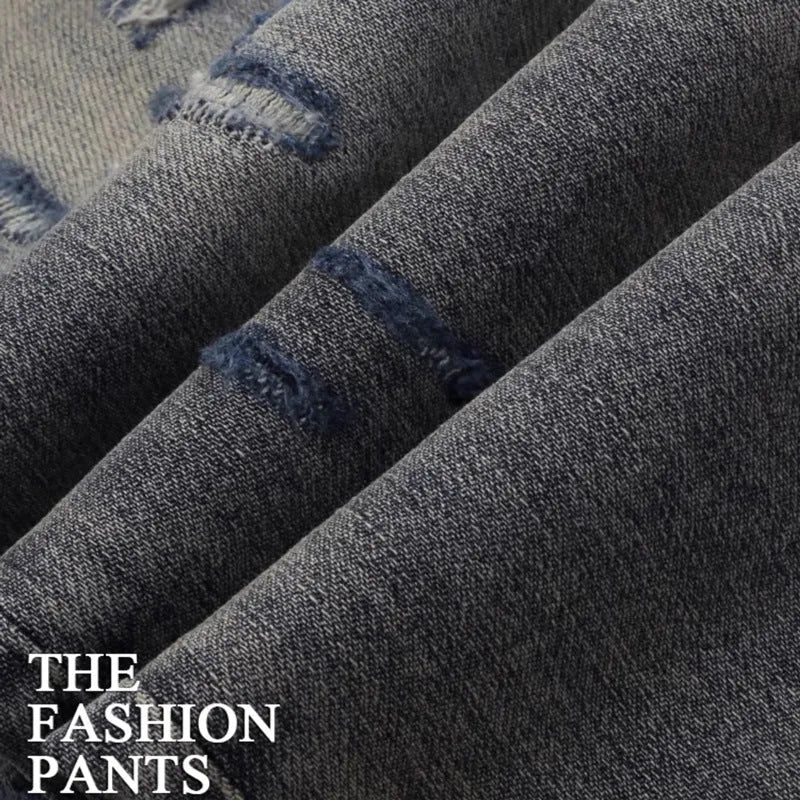 Men's slim fit jeans in a washed-out old colour with distressed hole and patch details on the legs.