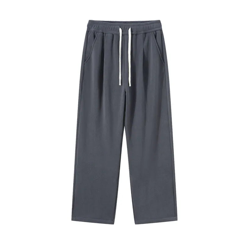 Men's apricot fleece-lined loose-fit sports casual trousers with elastic waist on a hanger.
