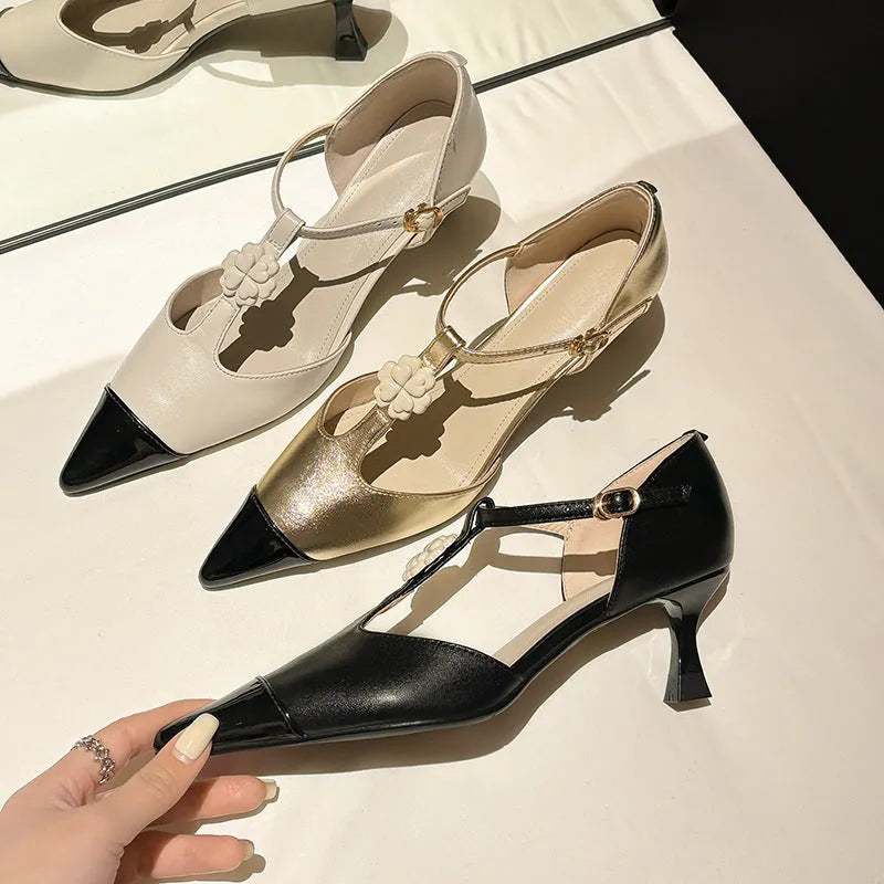 Women's black stiletto heel with pointed toe, floral detail, and a shallow mouth cut.