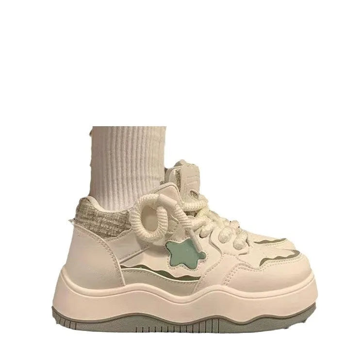 Women's green platform sneakers with patent leather finish and round toe front lace-up design